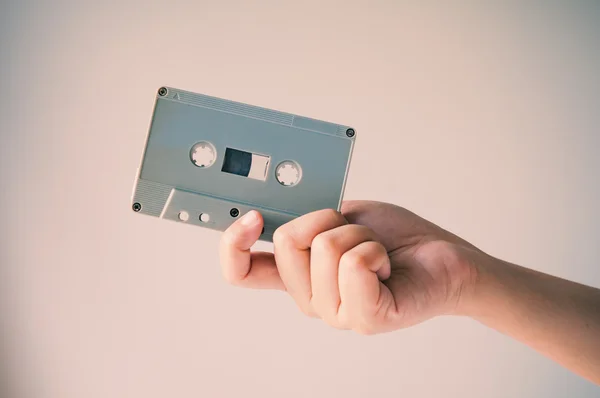 Hand offer old retro cassette tape. — Stock Photo, Image