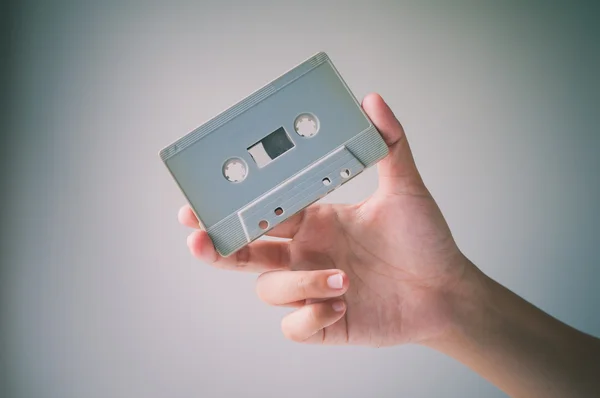 Hand offer old retro cassette tape. — Stock Photo, Image