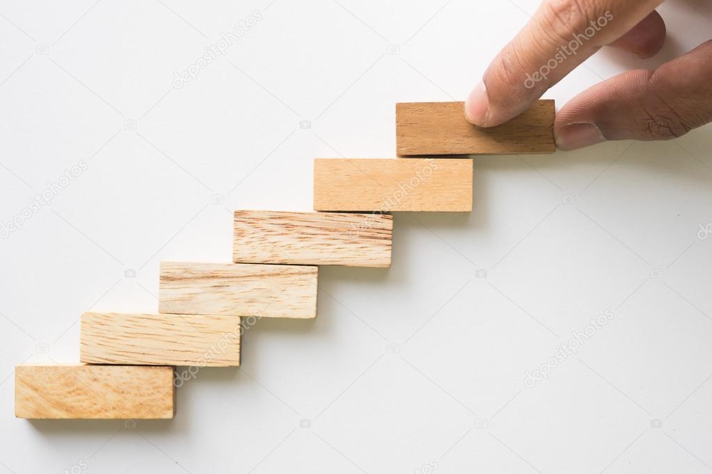 Hand aranging wood block stacking as step stair.