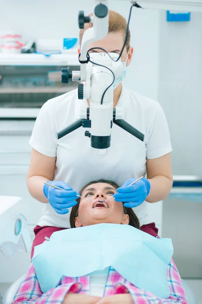 Kvinnlig Tandläkare Blå Gummihandskar Som Utför Mikroskopisk Rotfyllningsterapi Och Använder — Stockfoto