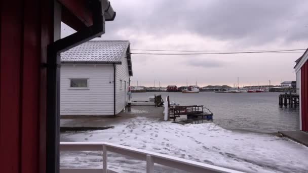 Typical charming village of snowy red cabins in Lofoten, Norway — Stock Video