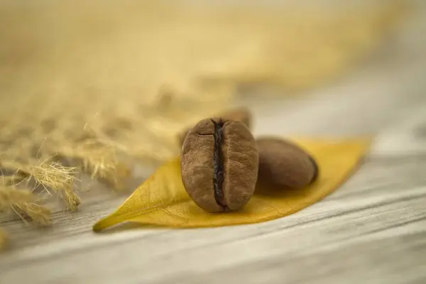 Roasted Coffee Beans Yellow Leaf Wooden Background Macro Photo — Stock Photo, Image