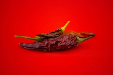 Kırmızı arka planda kurutulmuş kırmızı biber. Makro resim