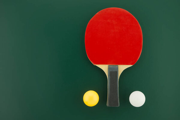 Table tennis equipment, racks and balls on green background with free copy space