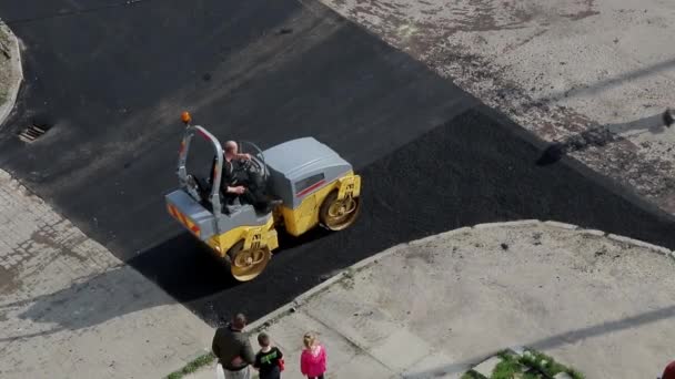 Mały walec parowy spłaszczający gorący asfalt na drodze. — Wideo stockowe