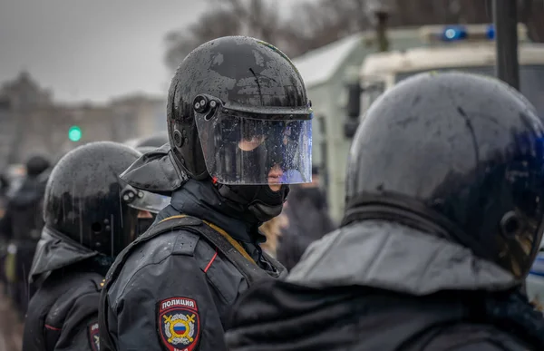 31 Ocak 2021, Rusya, Lipetsk, Navalny 'yi desteklemek için mitingler. Şiddetli yağmurda sisli ve kordona yağmur damlalarıyla kaplanmış kasketli bir polisin portresi.