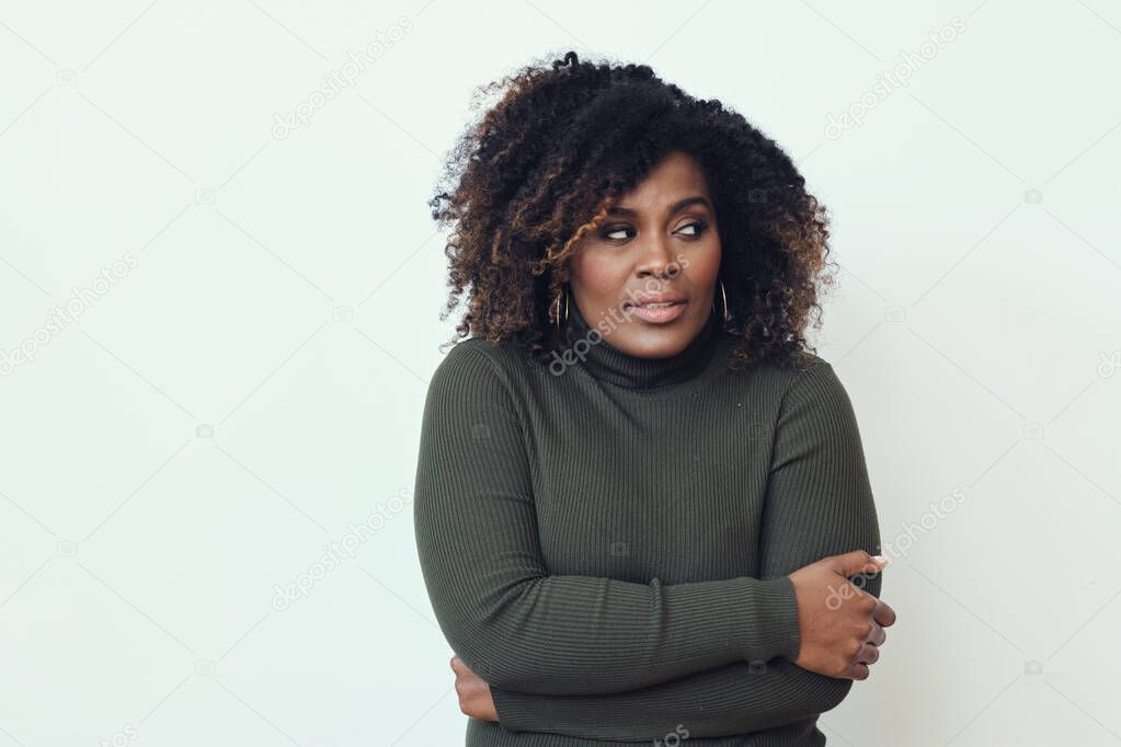 Thoughtful mid adult Afro woman looking away white background
