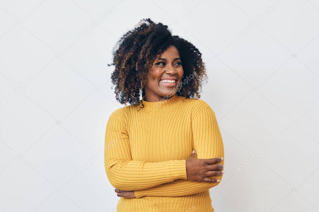 Portrait of smiling beautiful Afro woman standing against white background looking right