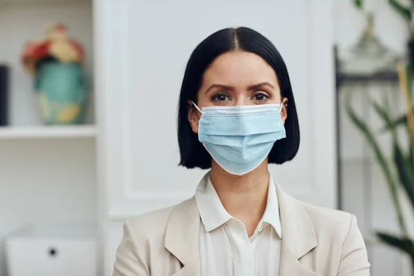 stock image young woman wearing medical mask and protective face masks at home