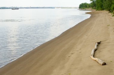 Doku, arka plan. kum plaj. gevşek taneli madde, soluk sarımsı kahverengi, silisli ve diğer kayalar erozyon kaynaklanan ve plajları büyük bir kurucu şekillendirme,