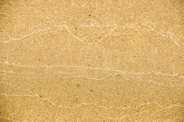 Textur, bakgrund. sanden på stranden. löst granulat subst — Stockfoto