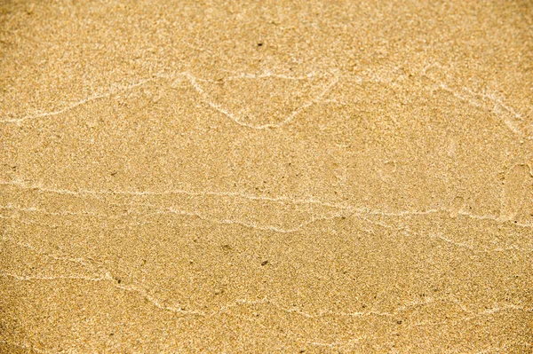 Textura, fondo. la arena en la playa. sustrato granular suelto — Foto de Stock