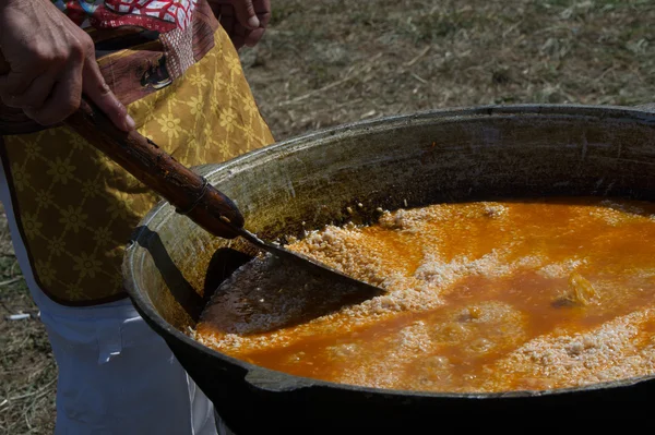 Uzbek national dish pilaf. a Middle Eastern or Indian dish of rice (or sometimes wheat) cooked in stock with spices, typically having added meat or vegetables.