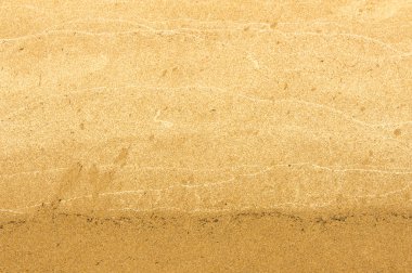 Doku, arka plan. kum plaj. gevşek taneli madde, soluk sarımsı kahverengi, silisli ve diğer kayalar erozyon kaynaklanan ve plajları büyük bir kurucu şekillendirme,