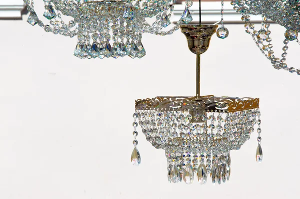 crystal chandeliers. a piece of a homogeneous solid substance having a natural geometrically regular form with symmetrically arranged plane faces.