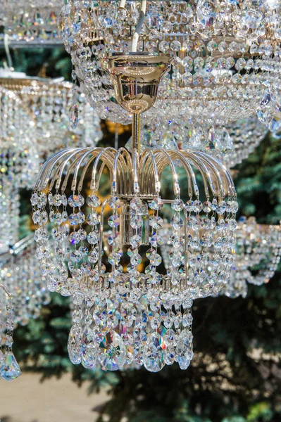 crystal chandeliers. a piece of a homogeneous solid substance having a natural geometrically regular form with symmetrically arranged plane faces.