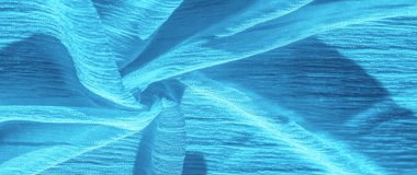 İpek kumaş. Mavi buruşuk kumaş dokusu. Mavi buruşuk, dalgalı yüzey dokusu. Yakın çekim, yumuşak odaklanma. arkaplan, kalıp