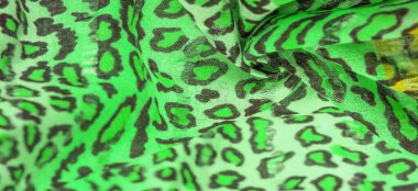 İpek kumaş yeşil, leopar desenli. Hafif leopar desenli ipek senin tasarımın için mükemmel, şık görünüyor ve kaba değil! Doku, arkaplan, desen