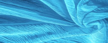 İpek kumaş. Mavi buruşuk kumaş dokusu. Mavi buruşuk, dalgalı yüzey dokusu. Yakın çekim, yumuşak odaklanma. arkaplan, kalıp