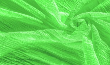 İpek kumaş. Yeşil kırışık kumaş dokusu. Yeşil buruşuk, dalgalı yüzey dokusu. Yakın çekim, yumuşak odaklanma. arkaplan, kalıp