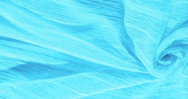 İpek kumaş. Mavi buruşuk kumaş dokusu. Mavi buruşuk, dalgalı yüzey dokusu. Yakın çekim, yumuşak odaklanma. arkaplan, kalıp