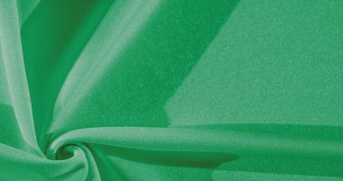 Yeşil ipek. Pürüzsüz, zarif yeşil ipek kumaş, fotokopi alanı ile soyut bir arkaplan olarak kullanılabilir. Renkli doku
