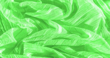 İpek kumaş. Yeşil kırışık kumaş dokusu. Yeşil buruşuk, dalgalı yüzey dokusu. Yakın çekim, yumuşak odaklanma. arkaplan, kalıp