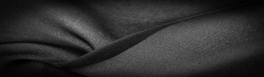 Arkaplan dokusu koyu siyah şifon ipeği yumuşak şeffaf bir kumaştır ve pürüzlüdür (matte, creped) çünkü bükülmüş iplik kullanımı.