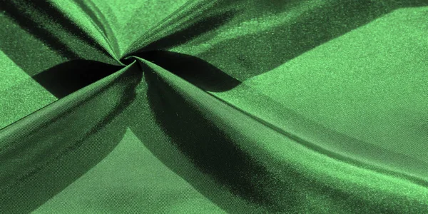 emerald green silk fabric, metallic fabric shades, shiny green metallic background for decorative design, decor element, wallpaper. texture pattern