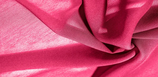 Background texture of silk fabric. This is a natural red scarf, this beautiful nylon satin made of artificial silk with a transparent hand and a wonderful sheen is perfect for your projects.