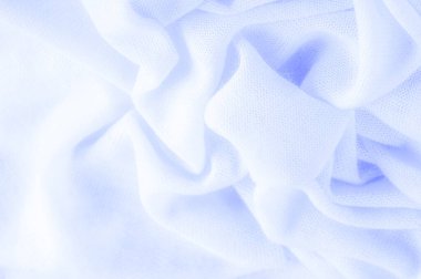 Mavi kumaş, lüks kumaşın soyut arkaplanı ya da dalgaların sıvı ipek dokusu ya da dalgalı kıvrımlar. arka plan ya da zarif duvar kağıdı tasarımı. Pamuk dokusu, doğal kumaş ve boya, parlak mavi renk.