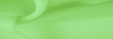 Doku. şablon. Açık yeşil ipek polyester. Kireç yeşili ipek kumaştan. Şeffaf arkaplan ve elbise dikmek için açık kumaştan yapılmış. Tekstil panoraması