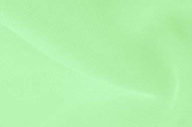 Doku. şablon. Açık yeşil ipek polyester. Kireç yeşili ipek kumaştan. Şeffaf arkaplan ve elbise dikmek için açık kumaştan yapılmış. Tekstil panoraması