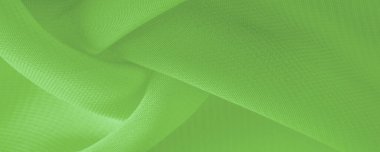 Doku. şablon. Açık yeşil ipek polyester. Kireç yeşili ipek kumaştan. Şeffaf arkaplan ve elbise dikmek için açık kumaştan yapılmış. Tekstil panoraması