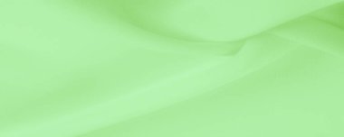 Doku. şablon. Açık yeşil ipek polyester. Kireç yeşili ipek kumaştan. Şeffaf arkaplan ve elbise dikmek için açık kumaştan yapılmış. Tekstil panoraması