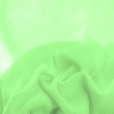 Yeşil kumaş. Lüks kumaşın soyut arka planı ya da dalgaların sıvı ipek dokusu ya da dalgalı kıvrımlar. arka plan ya da zarif duvar kağıdı tasarımı. Pamuk dokusu, doğal kumaş ve boya, parlak yeşil renk.