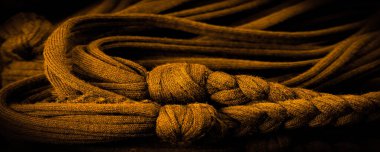 Doku, arka plan, desen. Sarı örgülü kumaş. Kabartmalı desenli örgü bir arka plan. Örgü ören örgüler..