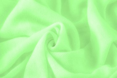 Yeşil kumaş. Lüks kumaşın soyut arka planı ya da dalgaların sıvı ipek dokusu ya da dalgalı kıvrımlar. arka plan ya da zarif duvar kağıdı tasarımı. Pamuk dokusu, doğal kumaş ve boya, parlak yeşil renk.