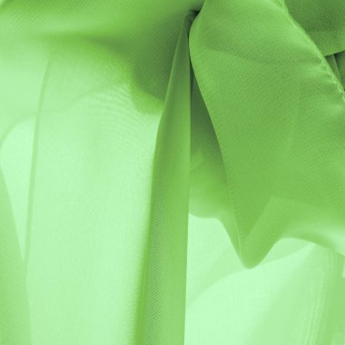 Doku. şablon. Açık yeşil ipek polyester. Kireç yeşili ipek kumaştan. Şeffaf arkaplan ve elbise dikmek için açık kumaştan yapılmış. Tekstil panoraması