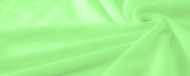Yeşil kumaş. Lüks kumaşın soyut arka planı ya da dalgaların sıvı ipek dokusu ya da dalgalı kıvrımlar. arka plan ya da zarif duvar kağıdı tasarımı. Pamuk dokusu, doğal kumaş ve boya, parlak yeşil renk.