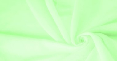 Yeşil kumaş. Lüks kumaşın soyut arka planı ya da dalgaların sıvı ipek dokusu ya da dalgalı kıvrımlar. arka plan ya da zarif duvar kağıdı tasarımı. Pamuk dokusu, doğal kumaş ve boya, parlak yeşil renk.