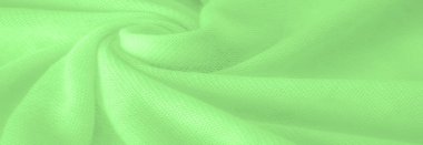 Yeşil kumaş. Lüks kumaşın soyut arka planı ya da dalgaların sıvı ipek dokusu ya da dalgalı kıvrımlar. arka plan ya da zarif duvar kağıdı tasarımı. Pamuk dokusu, doğal kumaş ve boya, parlak yeşil renk.