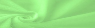 Yeşil kumaş. Lüks kumaşın soyut arka planı ya da dalgaların sıvı ipek dokusu ya da dalgalı kıvrımlar. arka plan ya da zarif duvar kağıdı tasarımı. Pamuk dokusu, doğal kumaş ve boya, parlak yeşil renk.