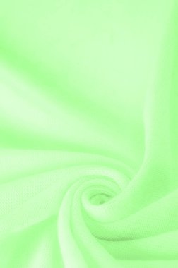 Yeşil kumaş. Lüks kumaşın soyut arka planı ya da dalgaların sıvı ipek dokusu ya da dalgalı kıvrımlar. arka plan ya da zarif duvar kağıdı tasarımı. Pamuk dokusu, doğal kumaş ve boya, parlak yeşil renk.