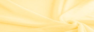 Sarı kumaş. Lüks kumaşın soyut arka planı ya da dalgaların sıvı ipek dokusu ya da dalgalı kıvrımlar. arka plan ya da zarif duvar kağıdı tasarımı. Pamuk dokusu, doğal kumaş ve boya, parlak sarı renk.