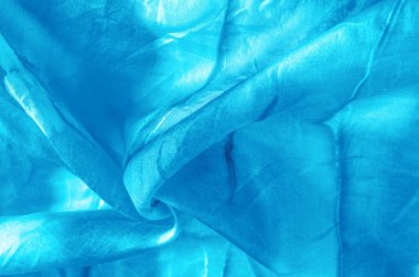 Turkuaz arka planda gri lekeli mavi kumaş. Soyut tasarımcı kumaş tasarımcısı. Tasarımın için güzel bir arka plan. Doku. Görüntü. çizim, kalıp, şekil