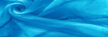 Turkuaz arka planda gri lekeli mavi kumaş. Soyut tasarımcı kumaş tasarımcısı. Tasarımın için güzel bir arka plan. Doku. Görüntü. çizim, kalıp, şekil