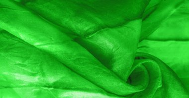 Yeşil arka planda gri lekeli yeşil kumaş. Soyut tasarımcı kumaş tasarımcısı. Tasarımın için güzel bir arka plan. Doku. Görüntü. çizim, kalıp, şekil