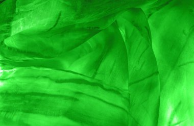 Yeşil arka planda gri lekeli yeşil kumaş. Soyut tasarımcı kumaş tasarımcısı. Tasarımın için güzel bir arka plan. Doku. Görüntü. çizim, kalıp, şekil