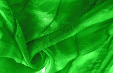 Yeşil arka planda gri lekeli yeşil kumaş. Soyut tasarımcı kumaş tasarımcısı. Tasarımın için güzel bir arka plan. Doku. Görüntü. çizim, kalıp, şekil